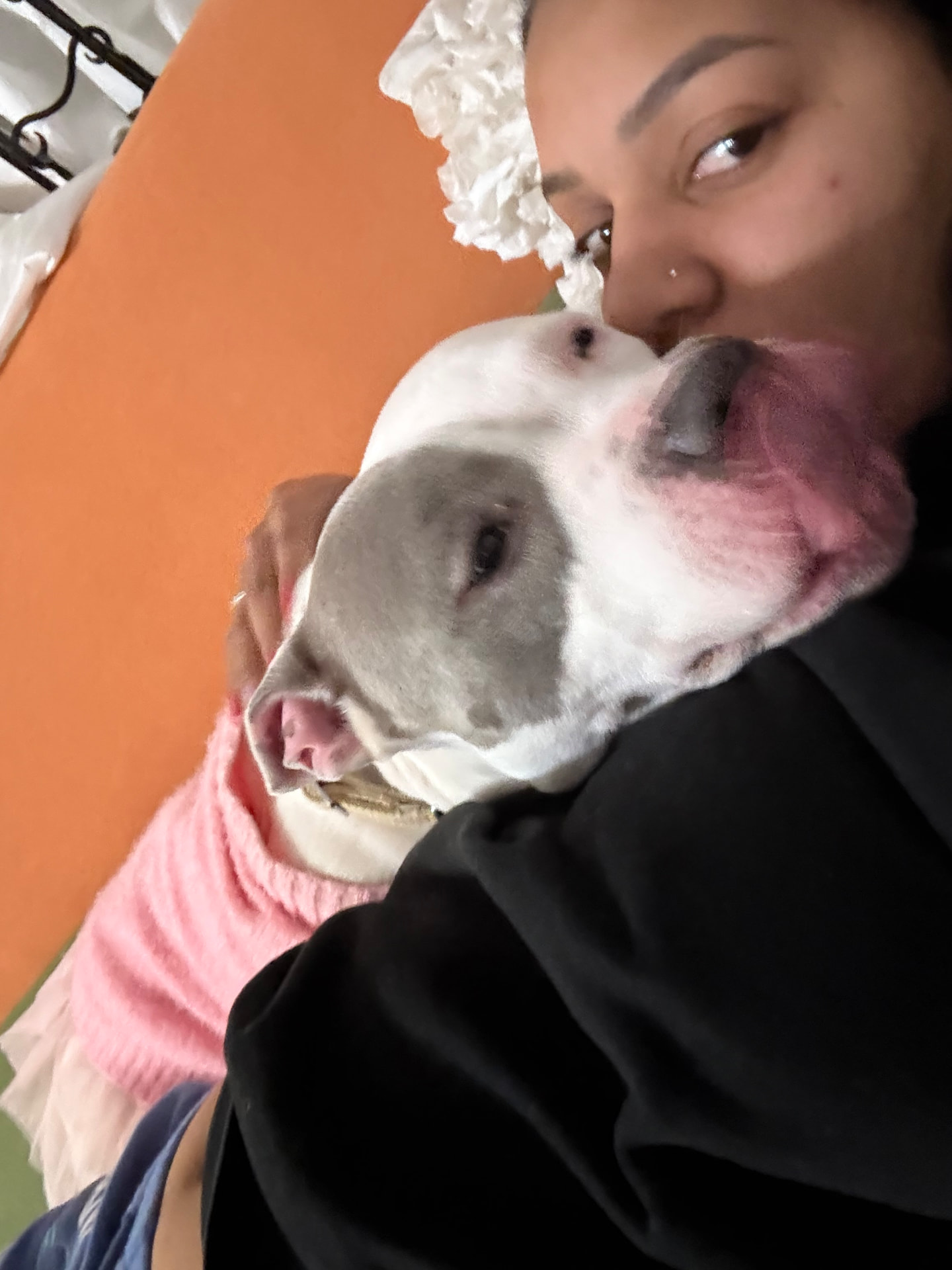 Karolyn smiling with a white pit bull